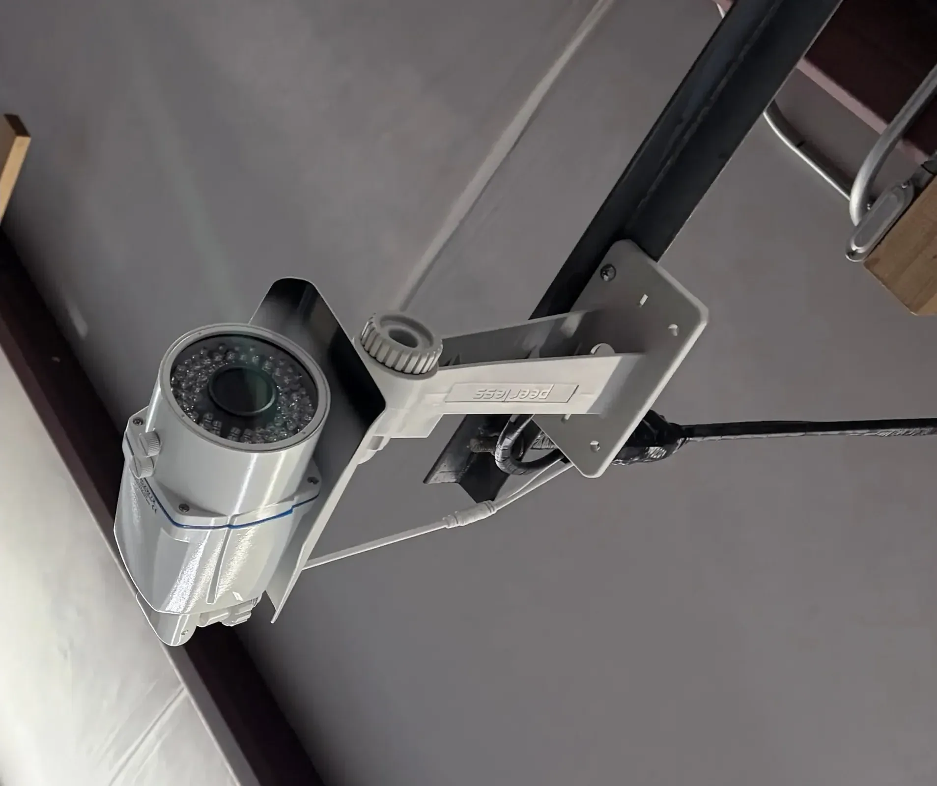 Ceiling-mounted security camera watching an interior storage hallway at the 24-hour monitored Staunton facility